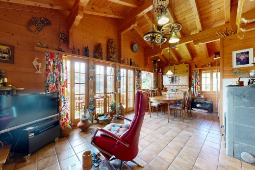 dining room with wood walls, suspended lighting, a high wood beamed ceiling, light tile patterned floors, and french doors