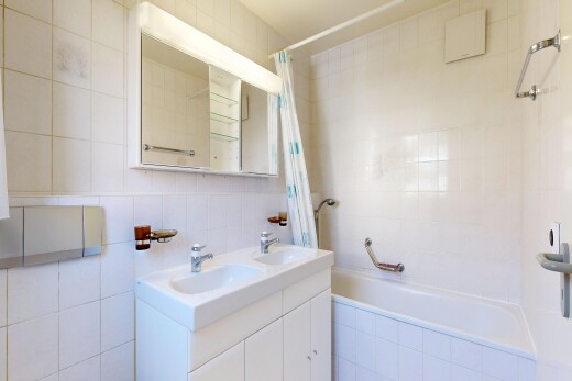 salle de bains avec salle de bain complète, mur en carrelage, tile wall, double vasque, et miroir