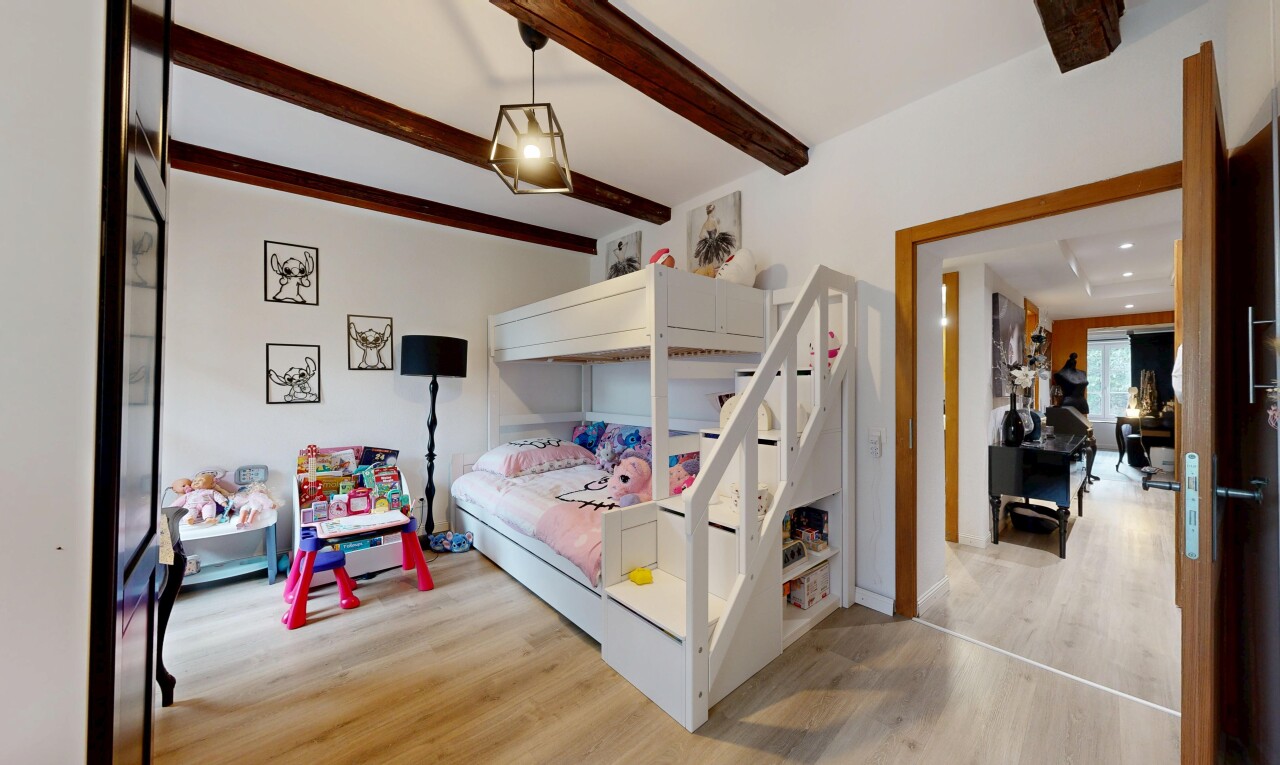 chambre avec inside property, sol en finition bois, wood finish floor, plafond à poutres, et beamed ceiling