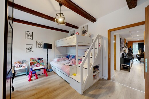 chambre avec inside property, sol en finition bois, wood finish floor, plafond à poutres, et beamed ceiling