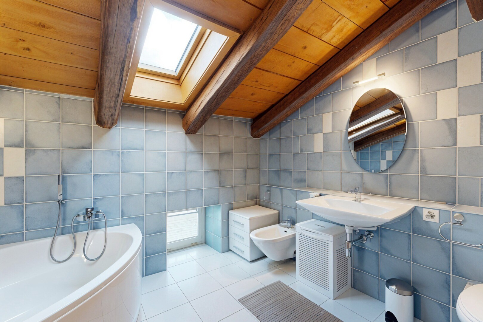 full bath featuring wooden ceiling, a garden tub, tile walls, tile patterned flooring, and a skylight