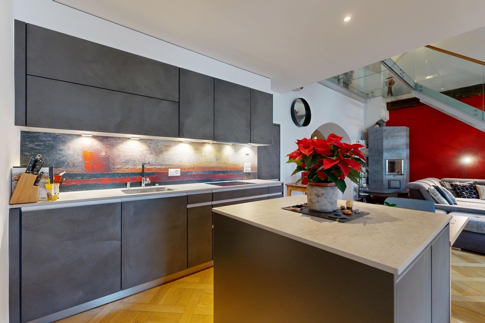 kitchen with modern cabinets, light countertops, a kitchen island, open floor plan, and tasteful backsplash