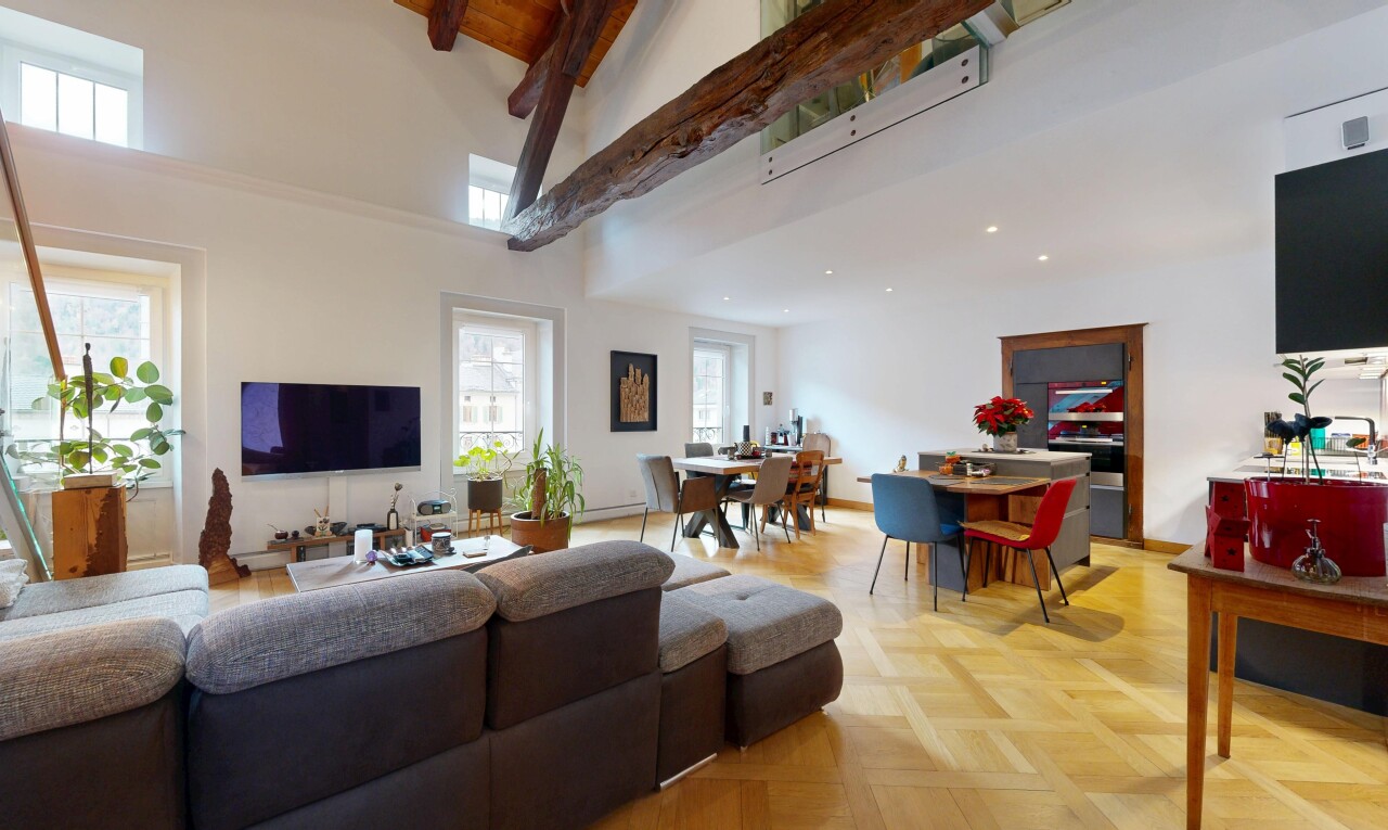 living area with beam ceiling and high vaulted ceiling