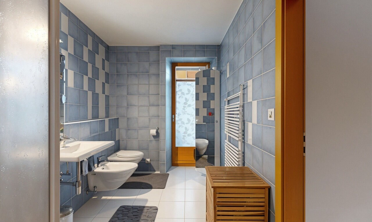 full bathroom featuring tile walls, a towel warmer, radiator heating unit, a bidet, and vanity