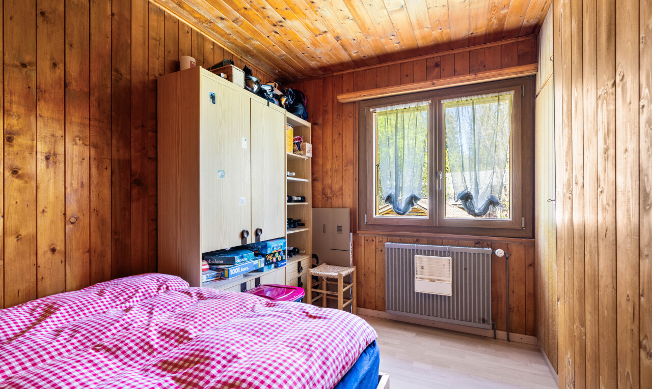 room featuring radiator heating unit, light wood finished floors, wooden ceiling, and wood walls