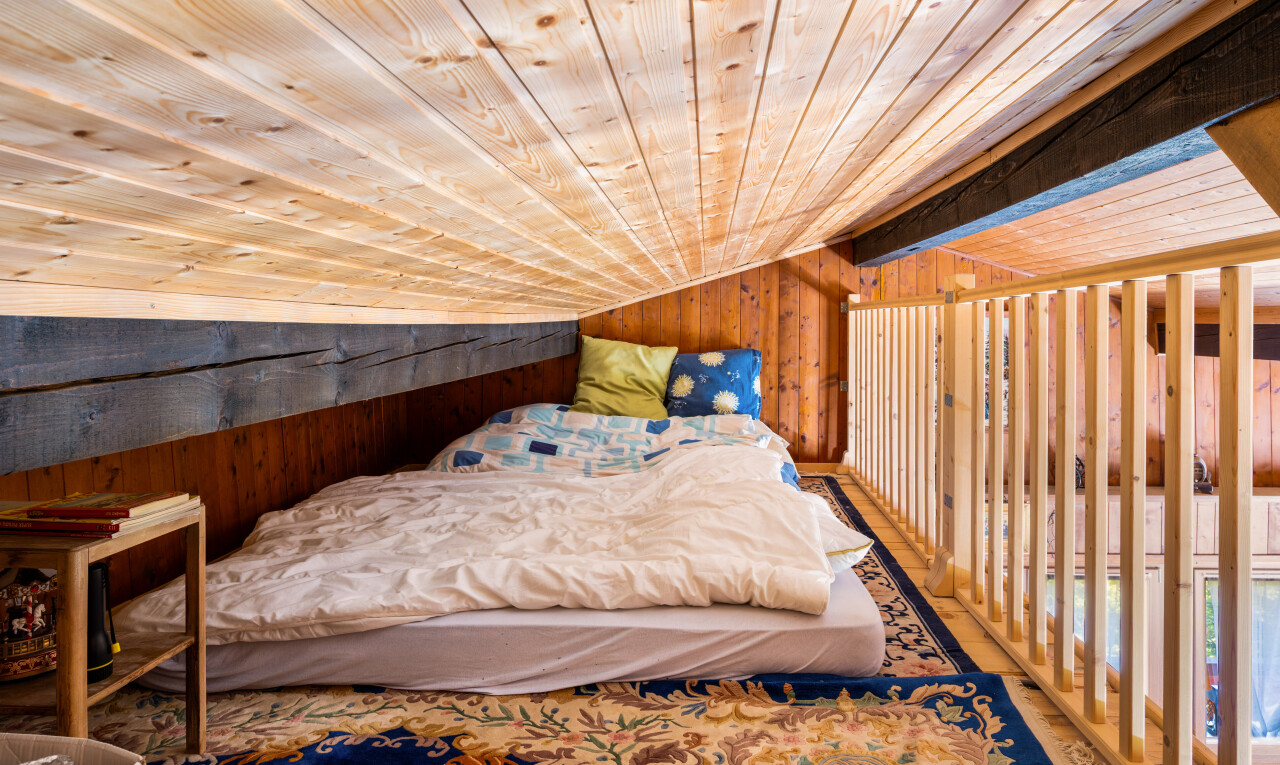 room with wood walls and a vaulted wooden ceiling