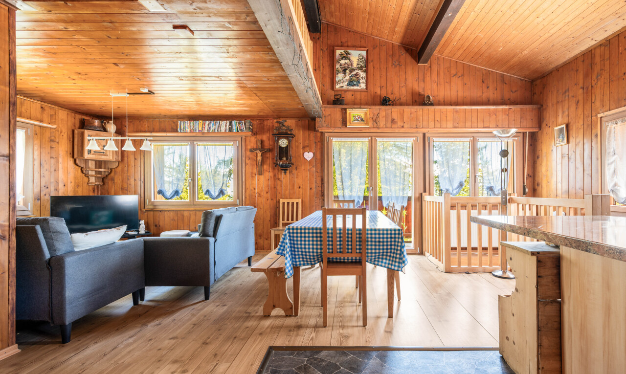 dining room featuring wood ceiling, light wood finished floors, lofted ceiling with beams, and wood walls
