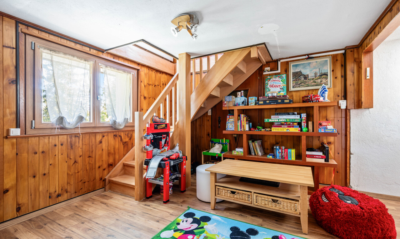staircase with wood finished floors and wood walls