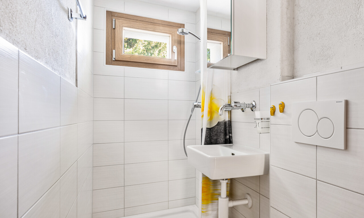 full bath with a stall shower and tile walls