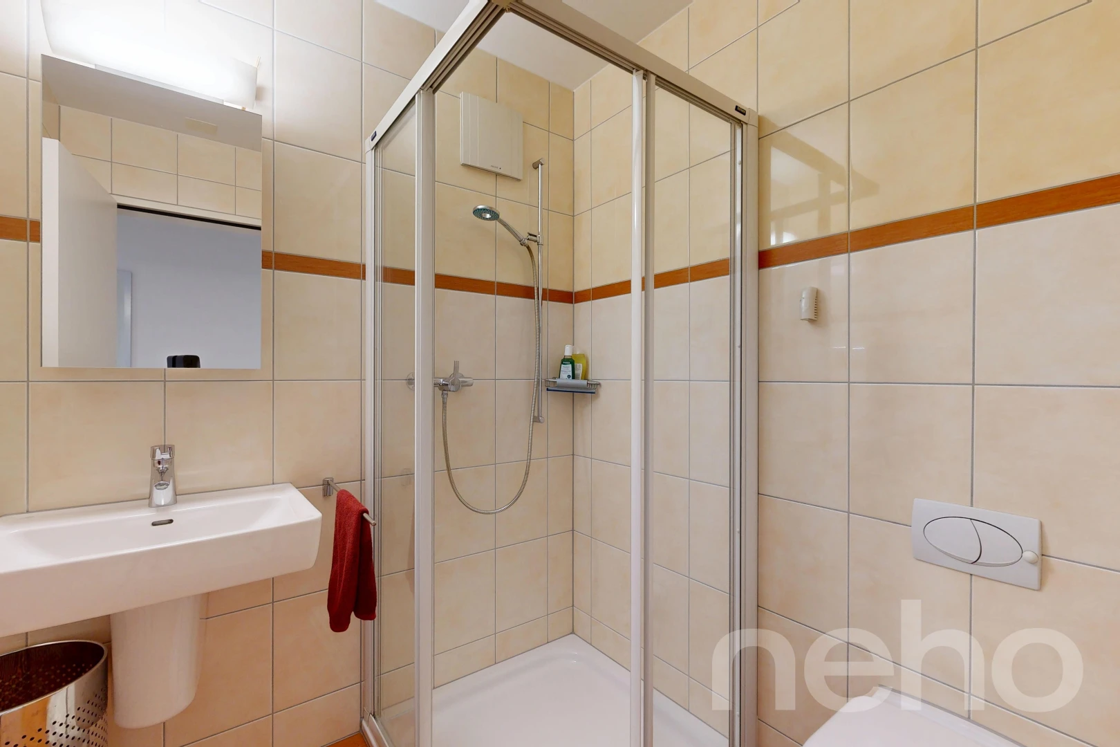 full bath with a shower stall and tile walls