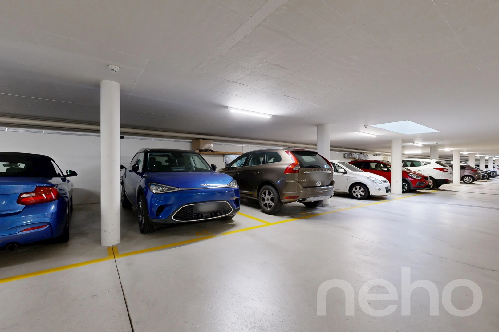 view of parking with a parking garage