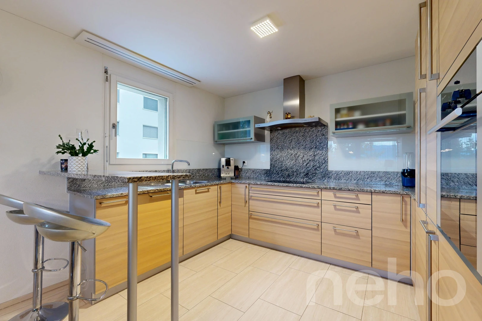 kitchen with dark stone counters, oven, backsplash, and modern cabinets
