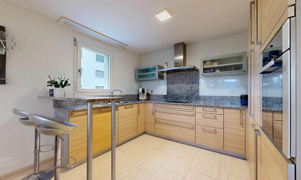kitchen with dark stone counters, oven, backsplash, and modern cabinets