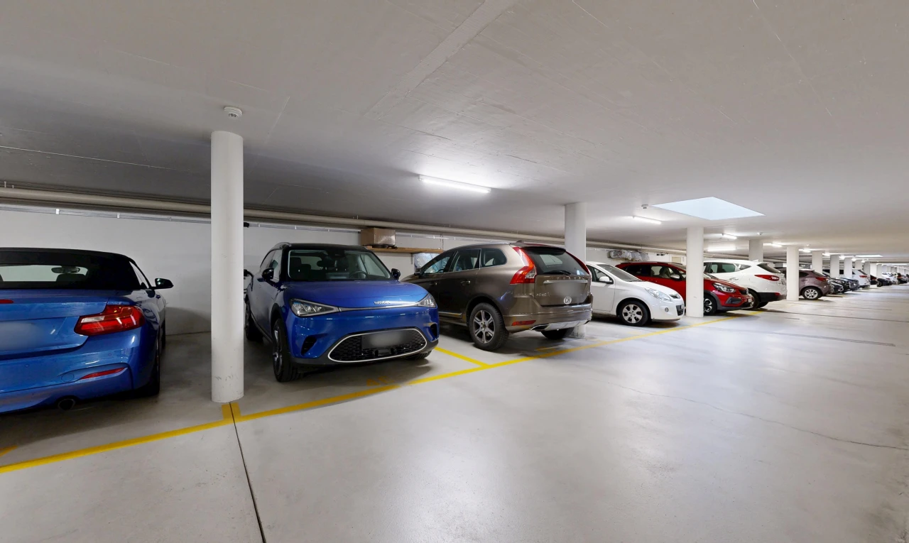 view of parking with a parking garage