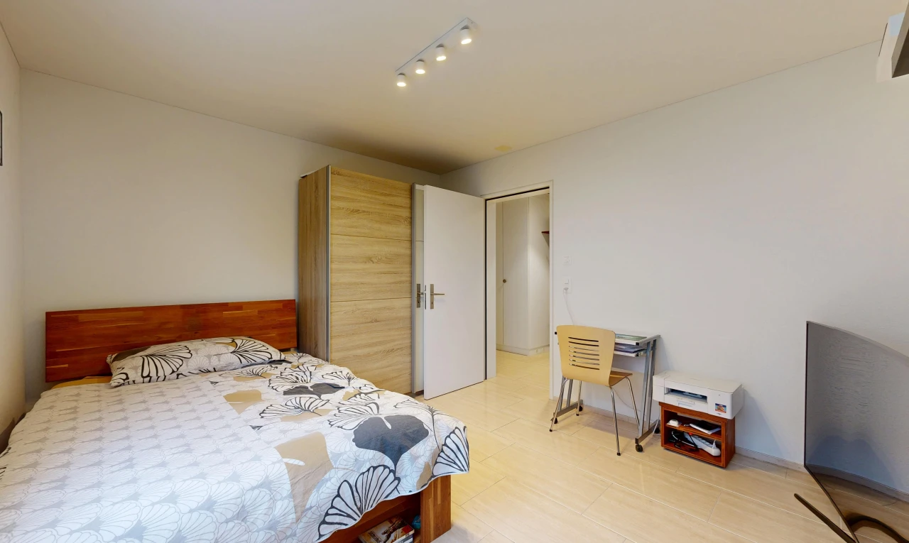 room with rail lighting and a desk