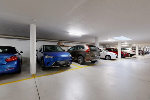 view of parking with a parking garage