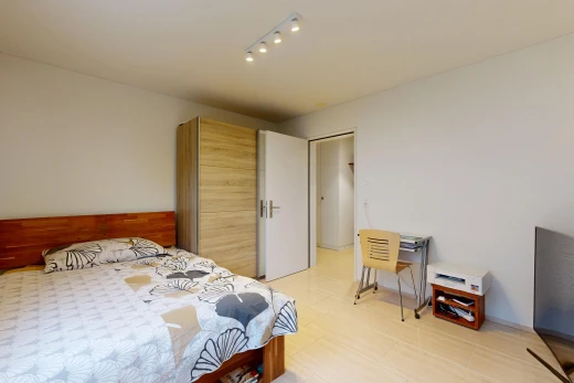 room with rail lighting and a desk