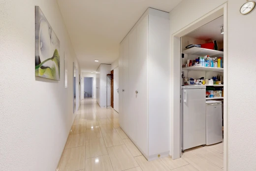 hallway with washer / dryer and recessed lighting