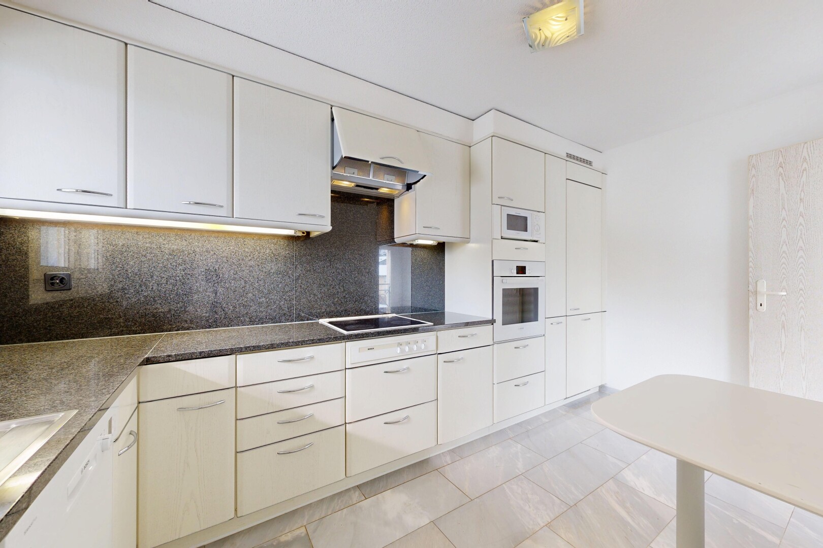 kitchen featuring backsplash, white appliances, dark countertops, and white cabinetry