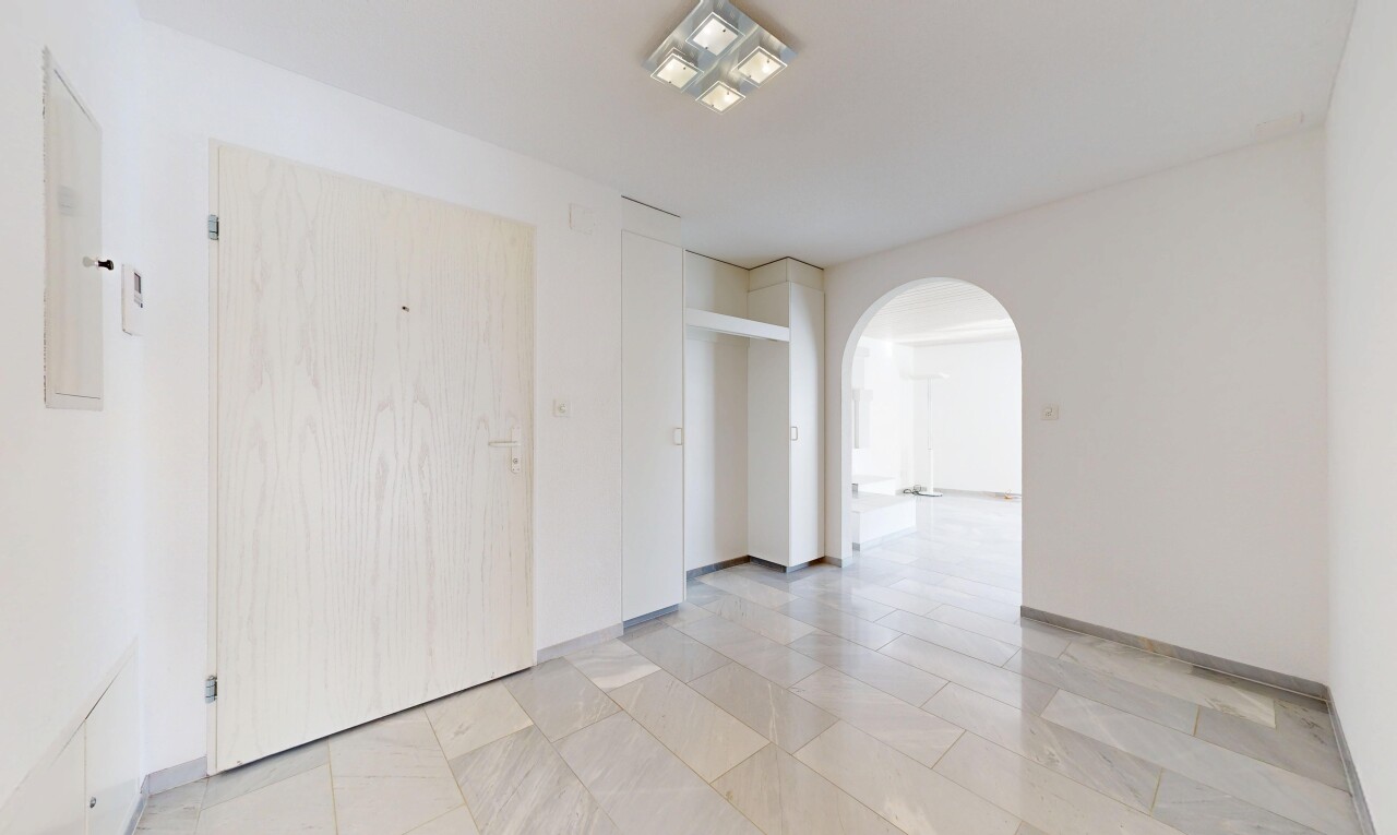 empty room featuring arched walkways