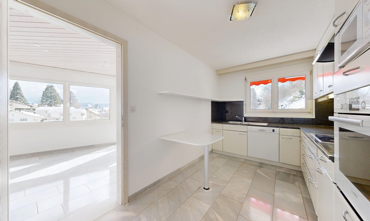 kitchen with dark countertops, white appliances, and white cabinetry