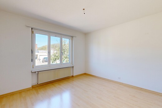 spare room with radiator heating unit and light wood-style floors