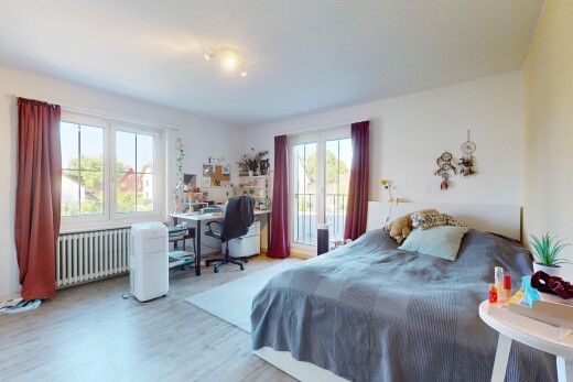 room with radiator heating unit, wood finished floors, and a desk