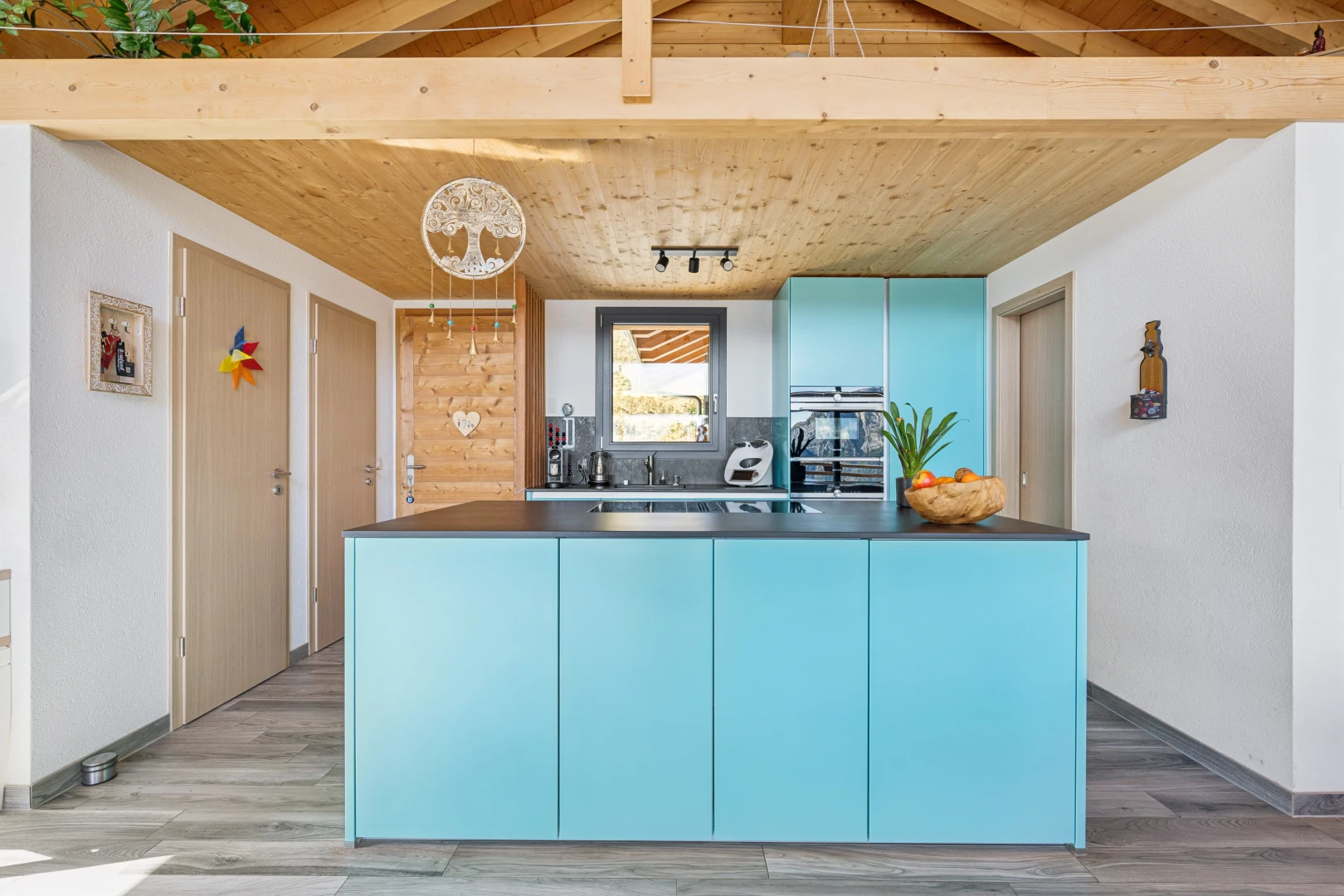 cuisine avec armoires bleues, blue cabinets, plafond en bois, wood ceiling, et plans de travail