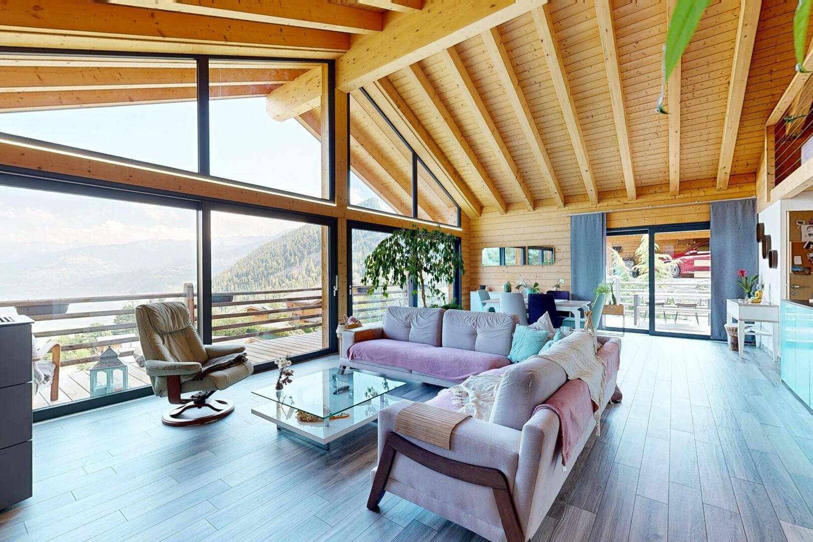 living room with hardwood / wood-style flooring, a high wood beamed ceiling, a mountain view, and wood walls