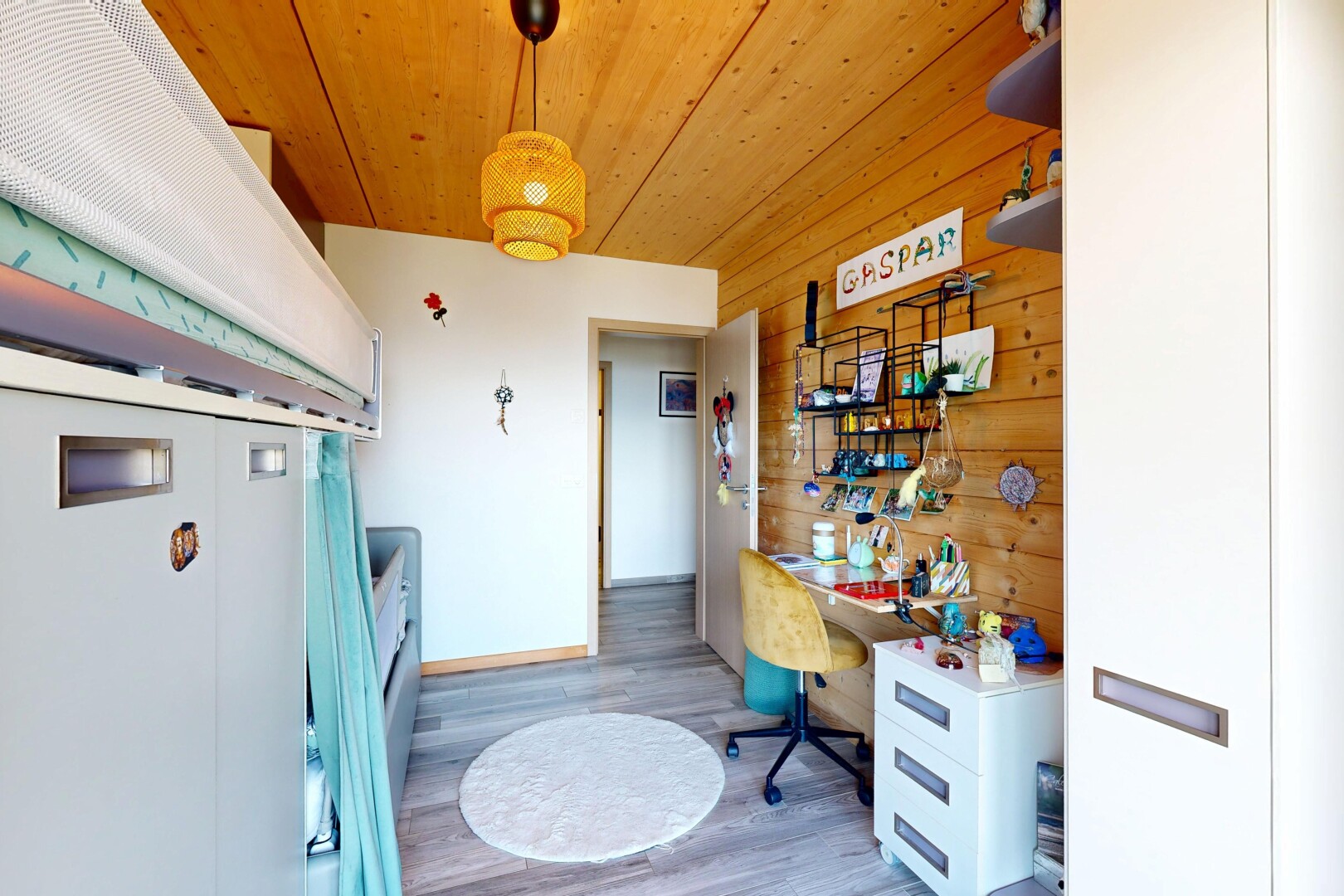 room / bedroom with hanging light fixtures, light wood finished floors, wooden ceiling, and wooden walls