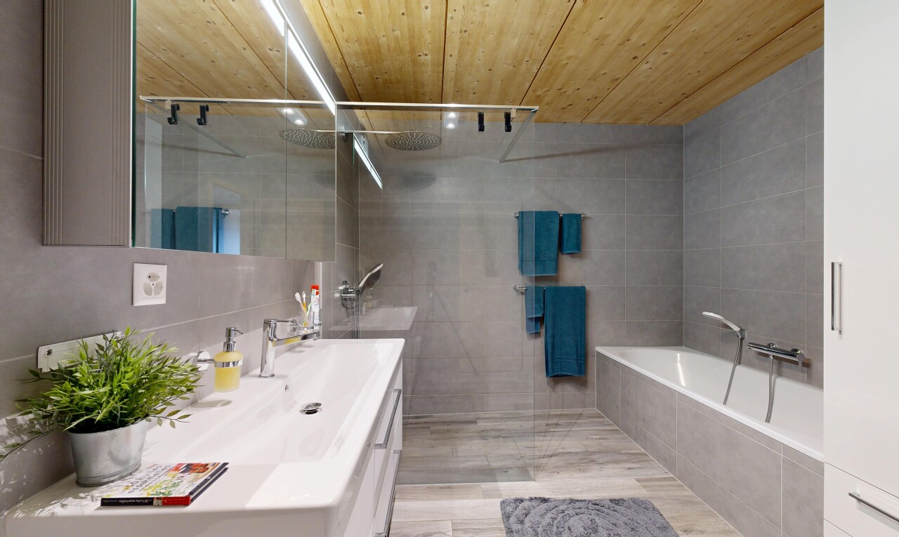 bathroom with wood ceiling, vanity, walk in shower, tile walls, and a garden tub