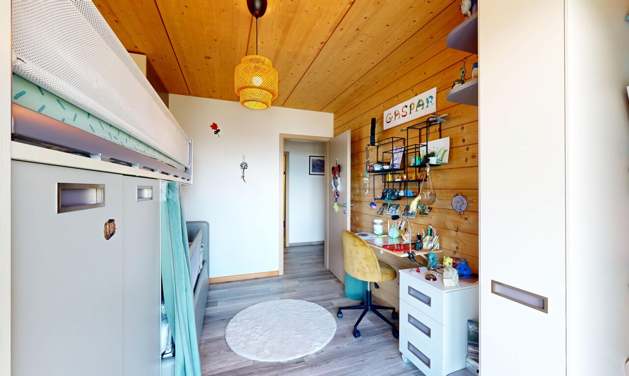 room / bedroom with hanging light fixtures, light wood finished floors, wooden ceiling, and wooden walls