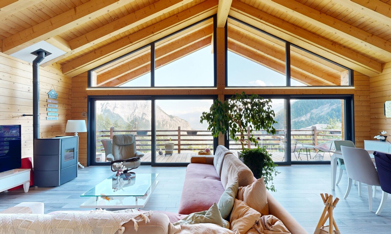 living area featuring wood walls, a high wood beamed ceiling, and wood finished floors