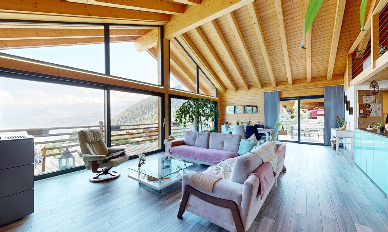 living room with hardwood / wood-style flooring, a high wood beamed ceiling, a mountain view, and wood walls
