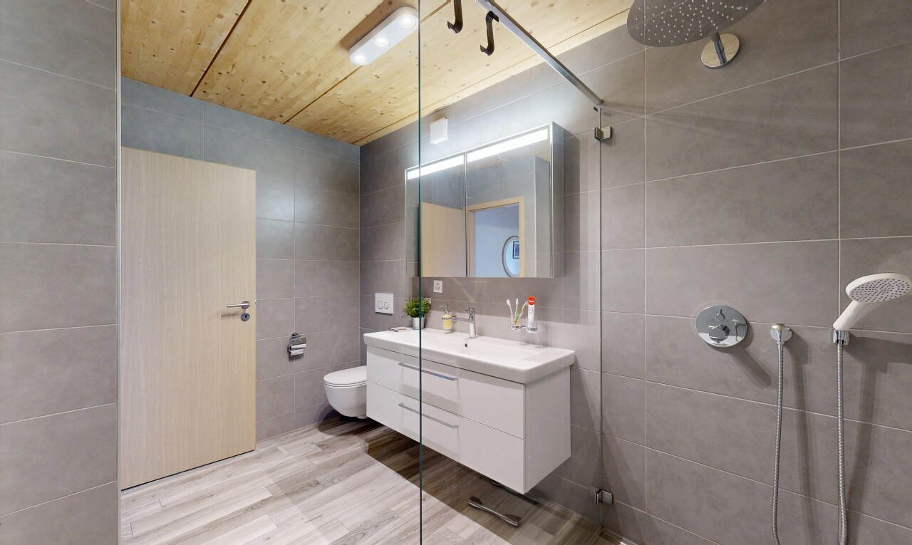 full bath featuring tile walls, wooden ceiling, tiled shower, vanity, and light wood-style floors