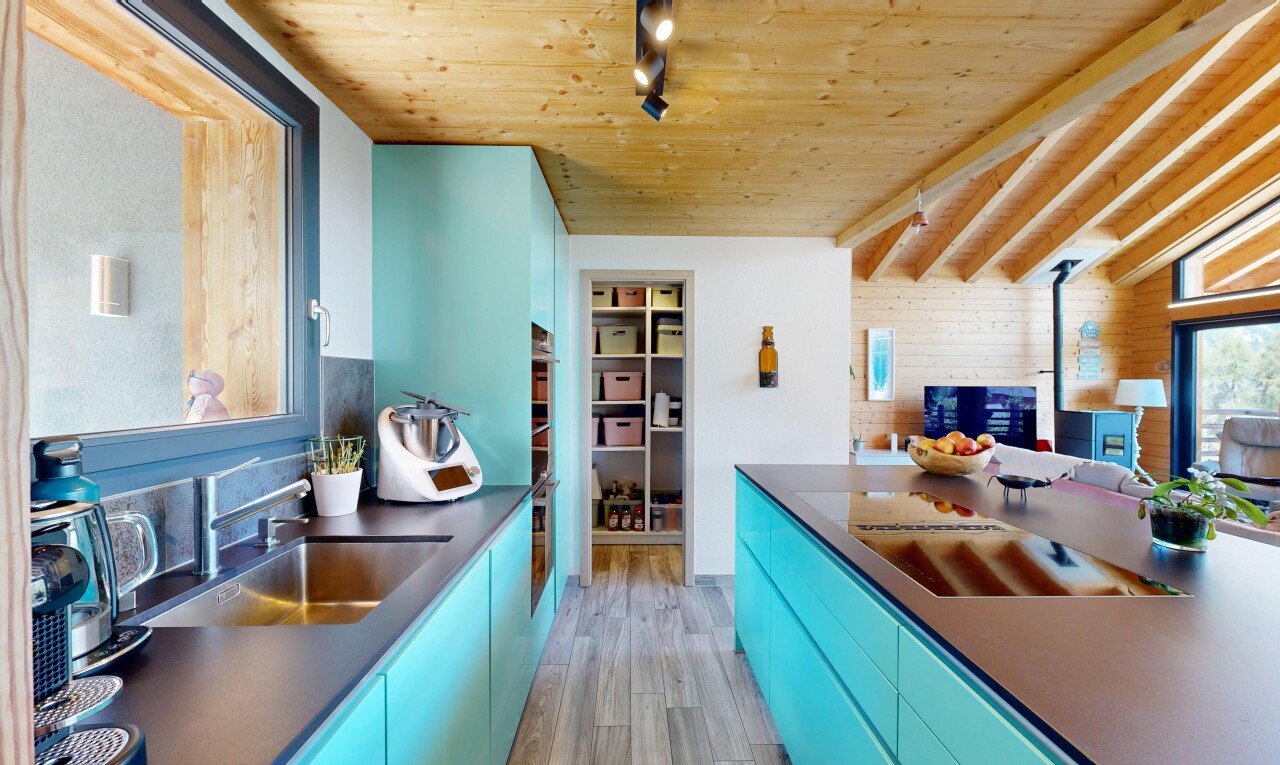 kitchen with blue cabinets, rail lighting, dark countertops, wooden ceiling, and modern cabinets