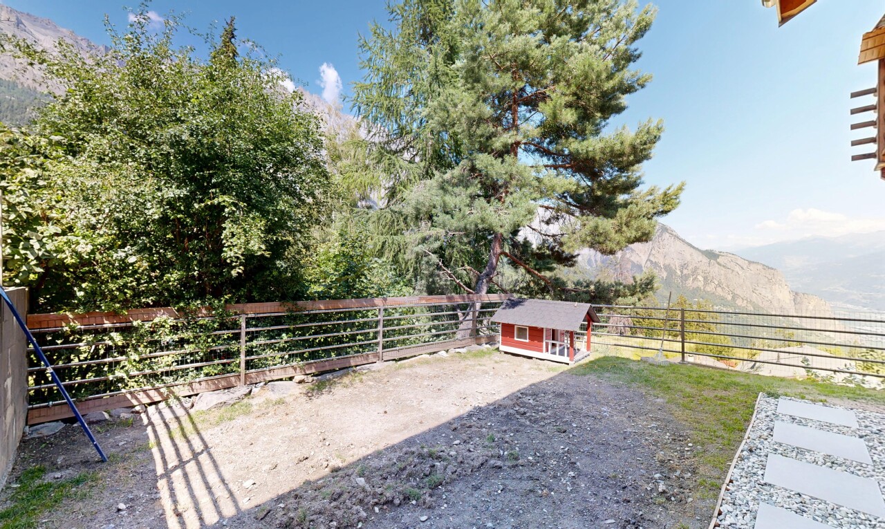 garden with an outdoor structure and a mountain view