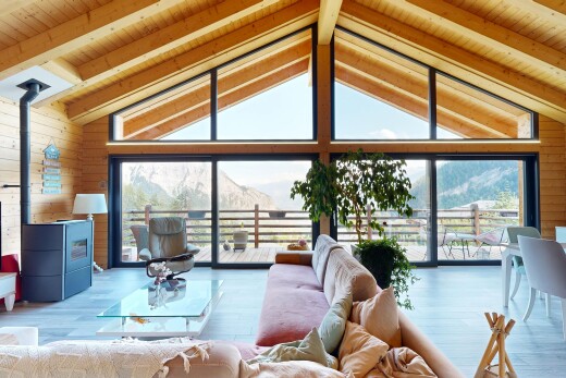 living area featuring wood walls, a high wood beamed ceiling, and wood finished floors