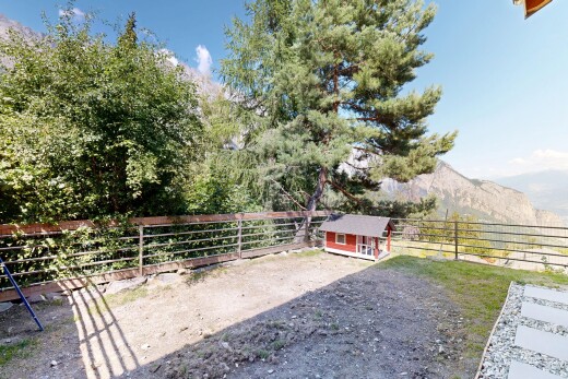 garden with an outdoor structure and a mountain view