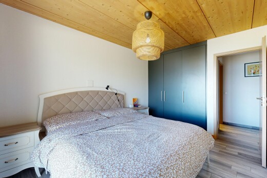 room featuring wooden ceiling, hanging light fixtures, light wood finished floors, and a closet