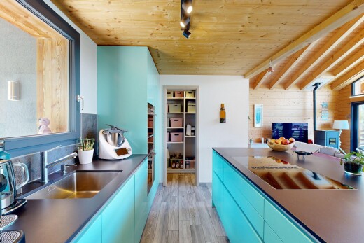 kitchen with blue cabinets, rail lighting, dark countertops, wooden ceiling, and modern cabinets