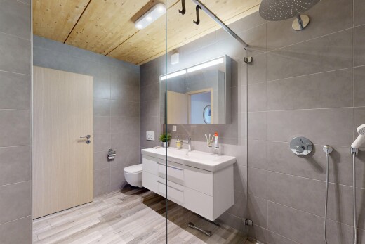 full bath featuring tile walls, wooden ceiling, tiled shower, vanity, and light wood-style floors
