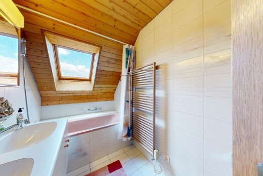full bath featuring a vaulted wood ceiling, a towel warmer, double vanity, light tile patterned floors, and radiator