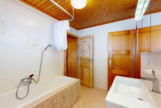 full bath featuring wooden ceiling, tiled bath, and a shower