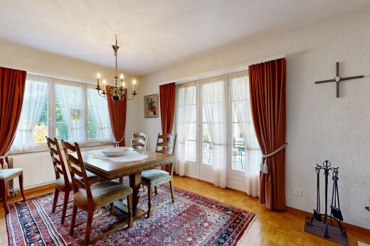 dining area featuring a chandelier and baseboards