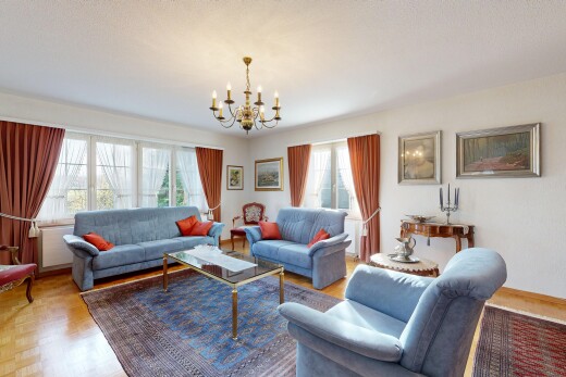 living area featuring a chandelier and wood finished floors
