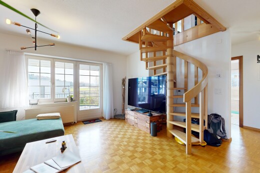 living room with plenty of natural light, a chandelier, and stairs