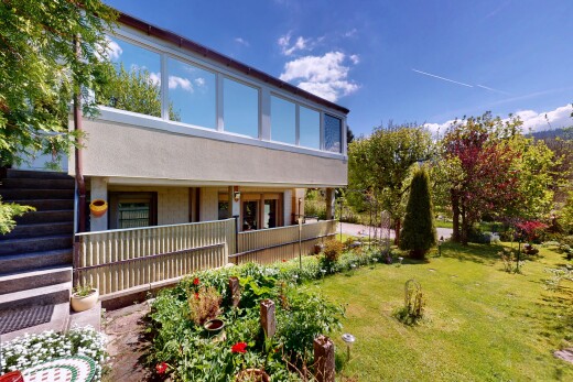 view of home featuring a lawn and a porch