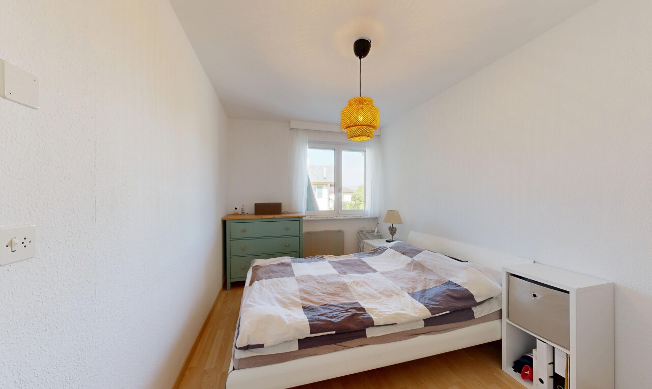 chambre avec éclairage suspendu, wood finish floor, sol en finition bois, lumière naturelle, et inside property