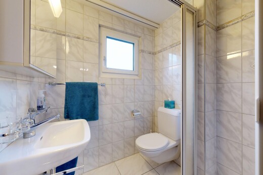 salle de bains avec salle de bain complète, mur en carrelage, tile wall, toilette, et miroir